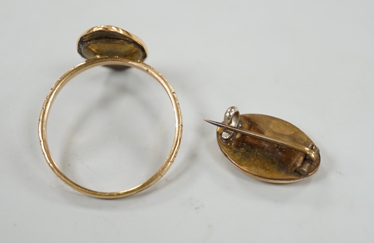 An early to mid 20th century yellow metal and two colour enamel navette shaped ring, size U and a matching brooch, gross weight 6.2 grams.